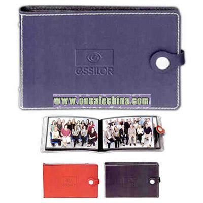 Leather photo album with decorative stitching and snap closure