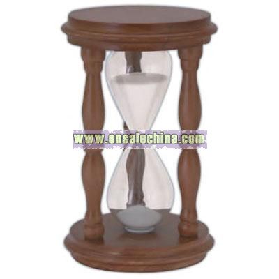 Traditional sand timer with wooden stand and white sand