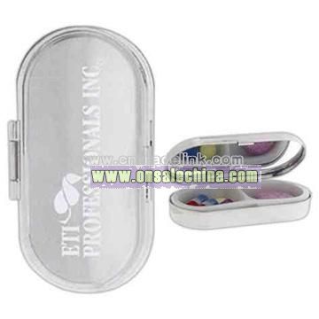 Metal pill case with two plastic compartments