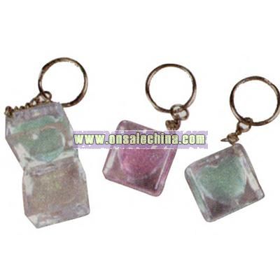 Square shaped key chain with heart shaped glitter lip gloss inlay