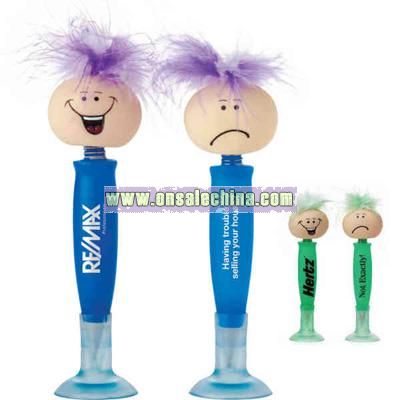 Novelty pen with suction cup cap and funny head at top of pen with two faces.