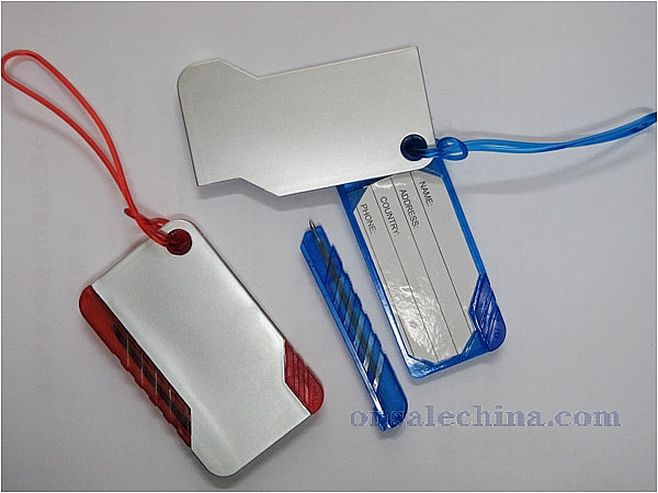 Luggage tag with pen